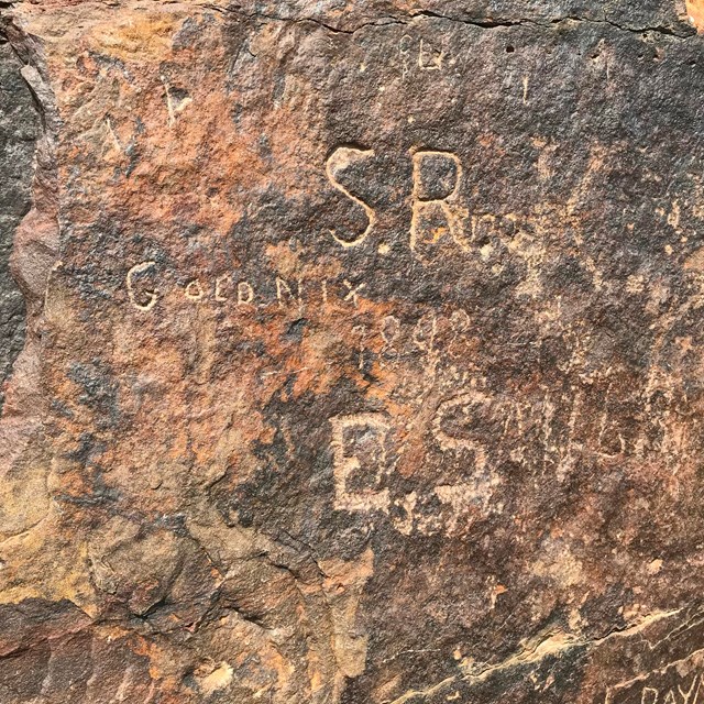 A rock with engraved names in it.