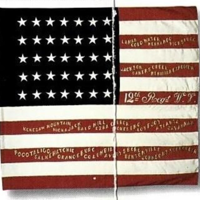 American flag with elaborate golden text on red stripes