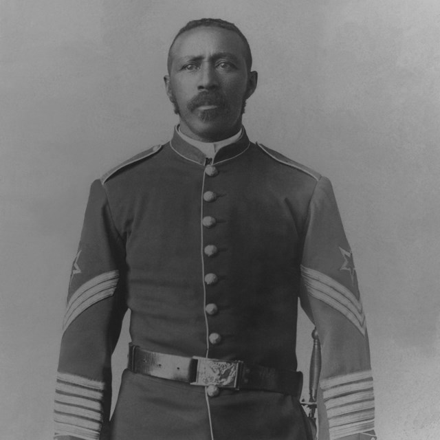 Black and white photo of a Black man wearing a military uniform.