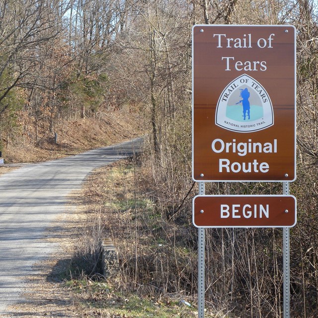 Sign post next to a trail. 