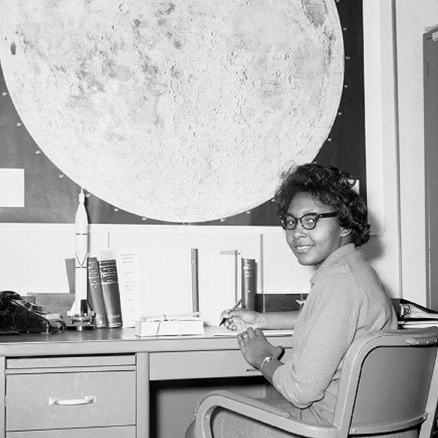 Woman sitting at a desk. 