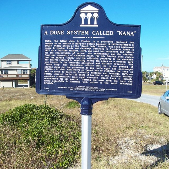 Interpretive sign with grass in background
