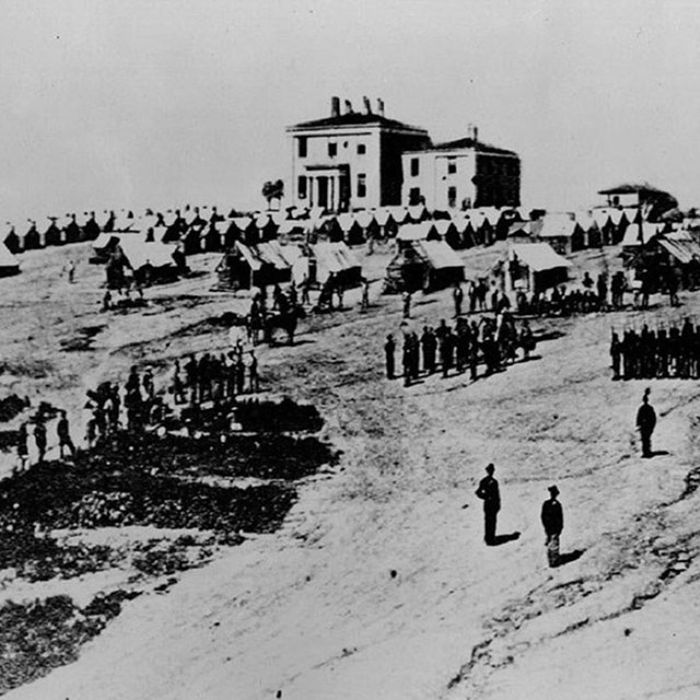 Black and white photo of soldiers on a hillside