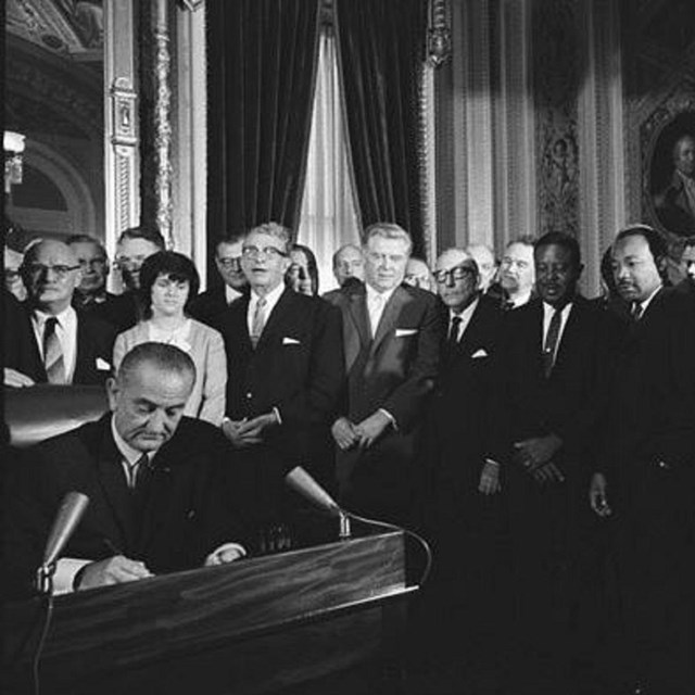 President Lyndon B. Johnson signs the Voting Rights Act of 1965 with Martin Luther King Jr.