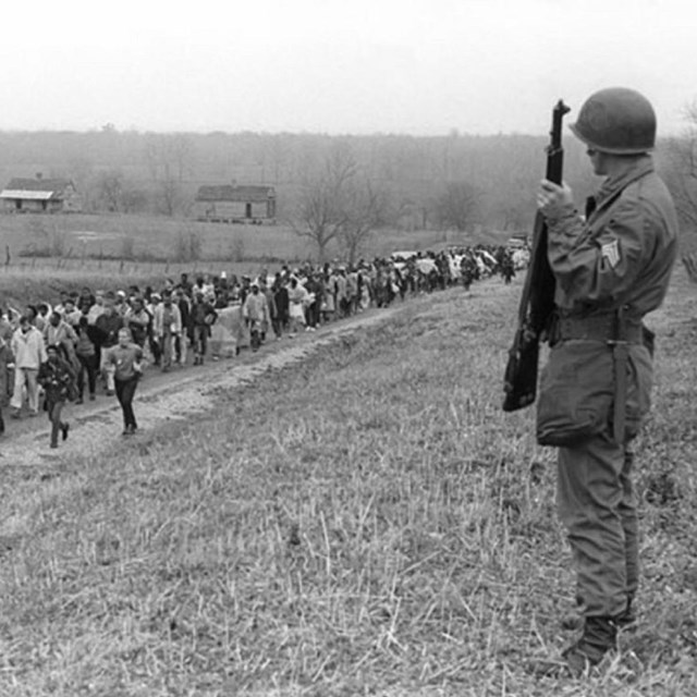 Marchers watched by law enforcement. 