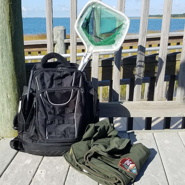 A Backpack with a dip net and jacket