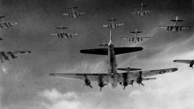 Several planes in the sky, flying in formation