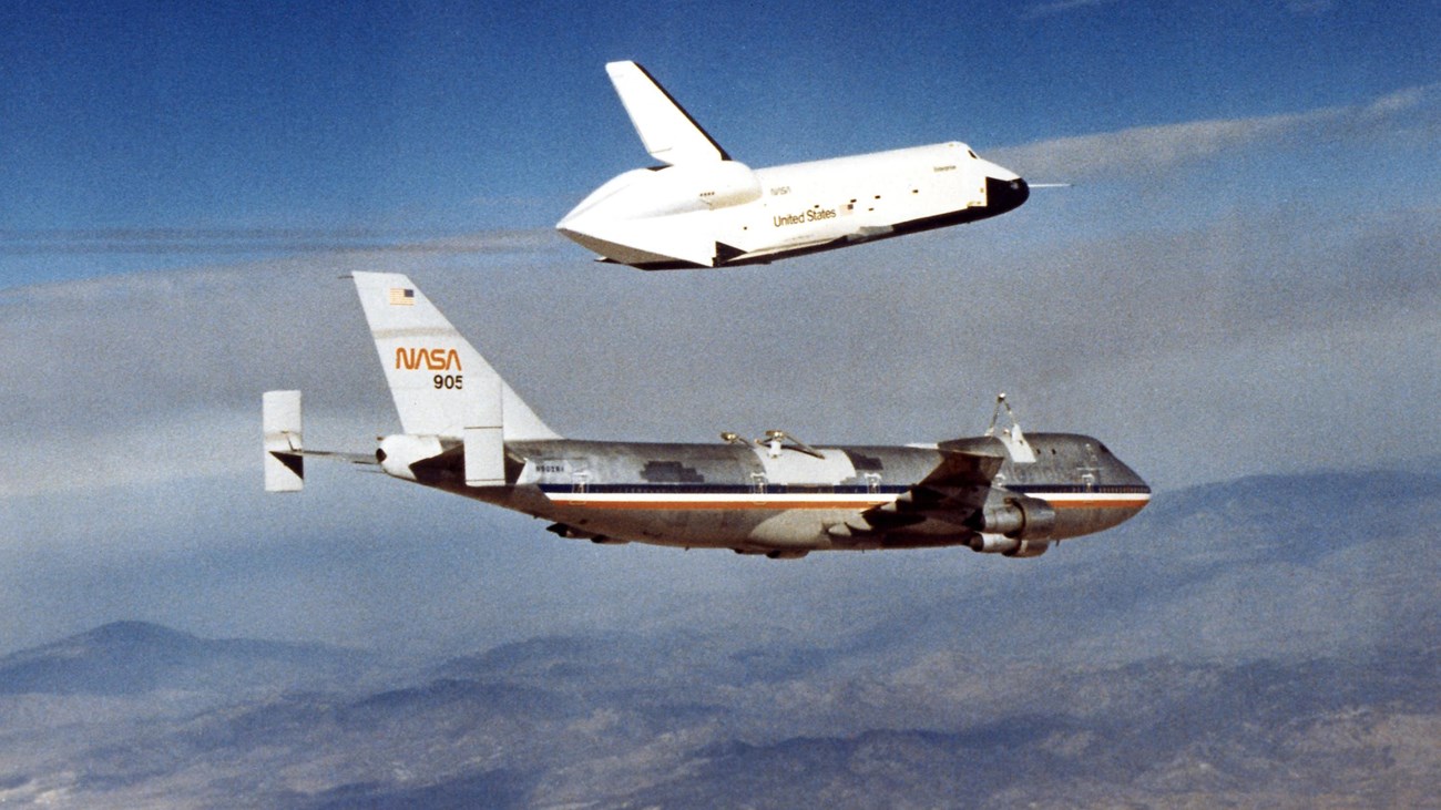 The space shuttle lifts off of the back of a large plane