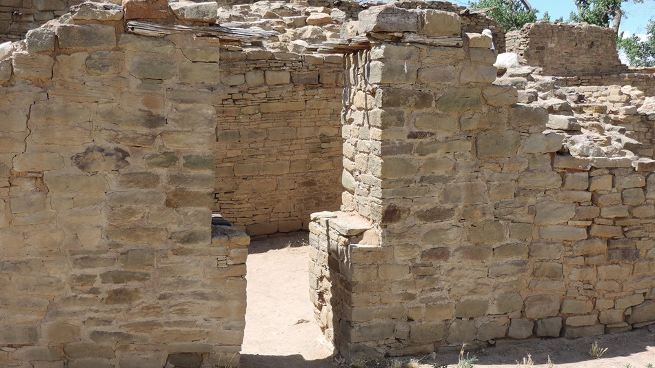 a t-shaped doorway in sandstone walls