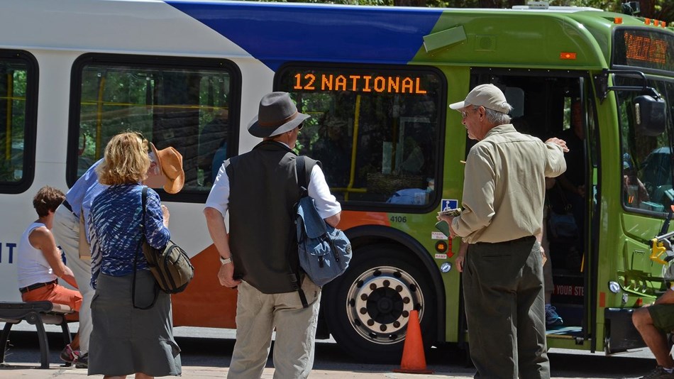 VIP directs visitor from shuttle bus