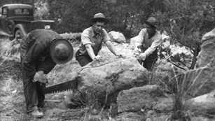 CCC workers cut a rock during construction