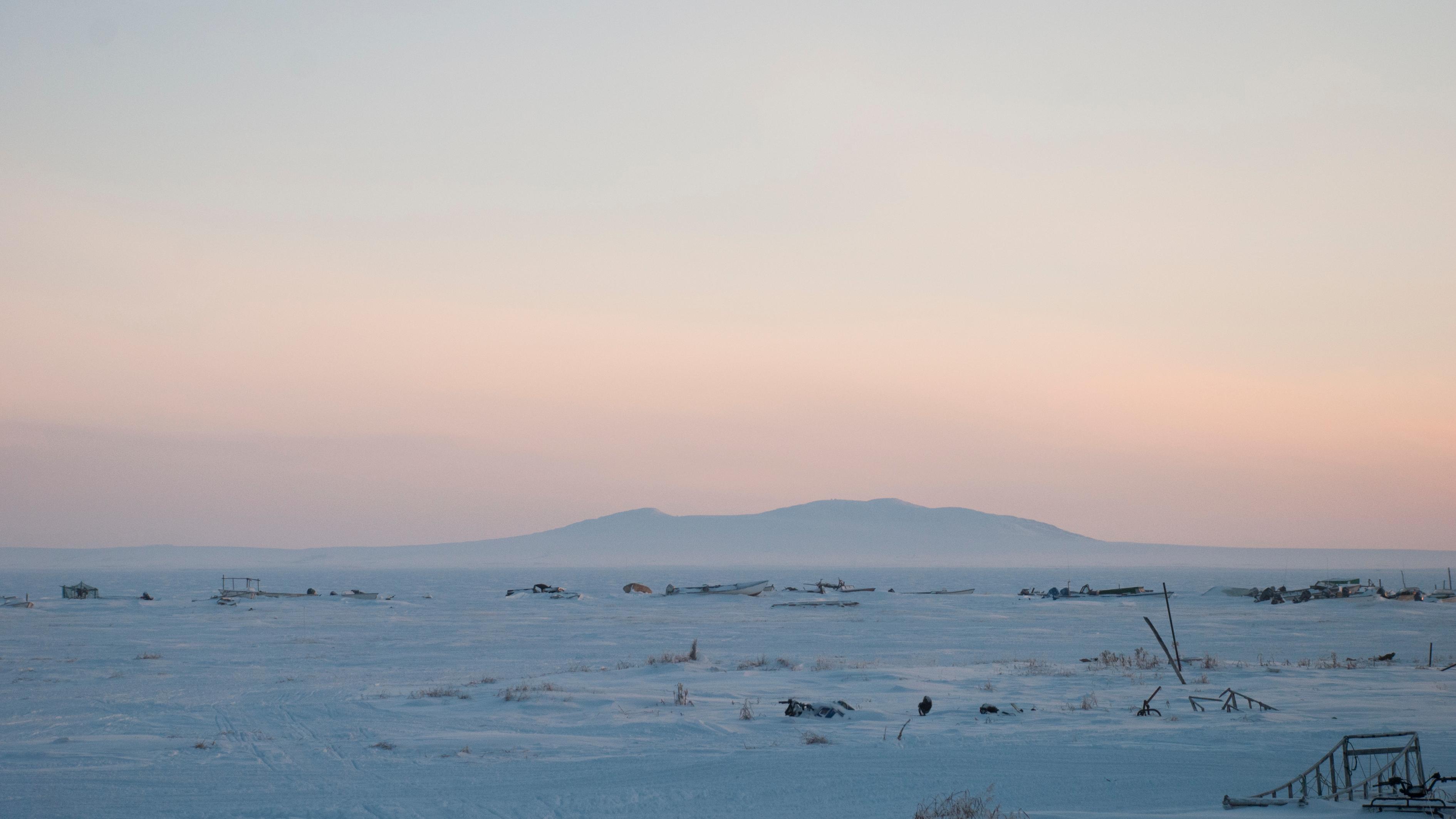 Ear Mountain in the hazy distance against a pinkish sky. 