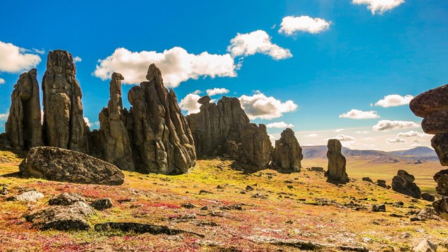 Giant tors emerging from a colorful landscape.