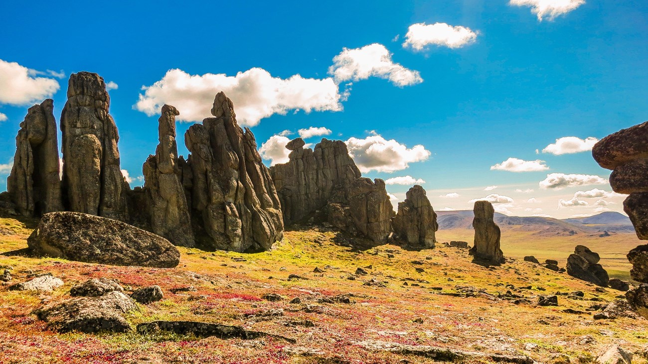 Giant tors emerging from a colorful landscape.