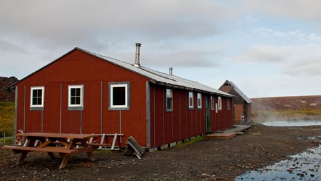 Portrait of a large red remote cabin. 