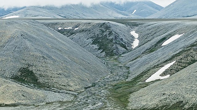 A vast expanse of rolling barren mountains within Bering Land Bridge National Preserve.