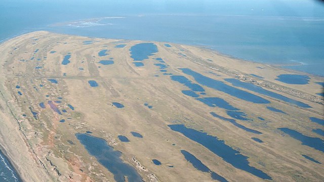 Aerial view of Cape Espenberg, a land that is partly submerged in water. 