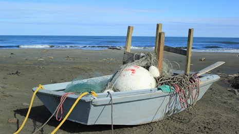 A wooden boat sits on the beach
