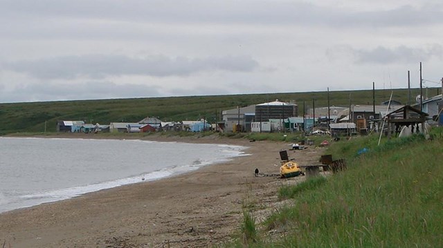 A small strip of houses line the beach. 