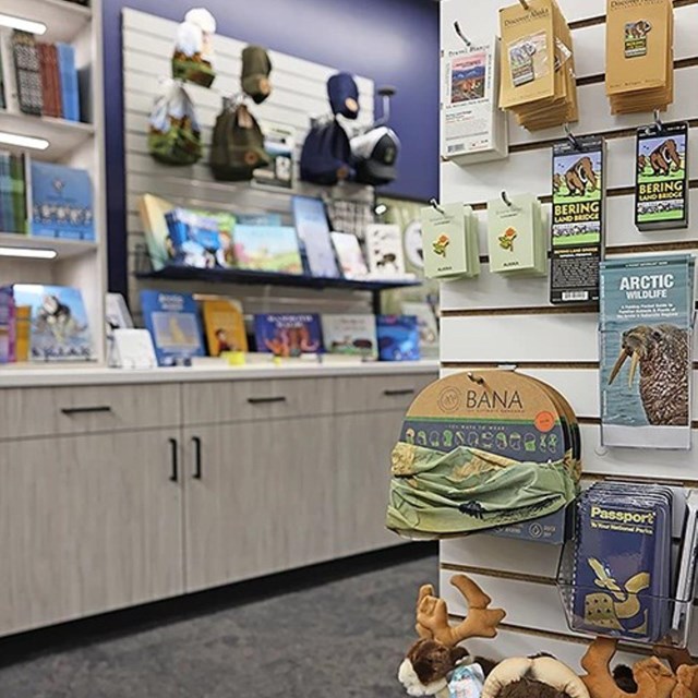 Items including pins, apparel, toys, park passports, and books on display at the Heritage Center.