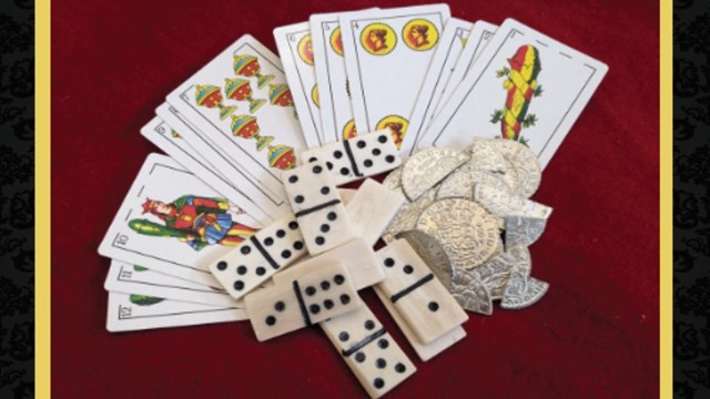 Photo of Spanish Monte playing cards, dominoes, and pieces of eight