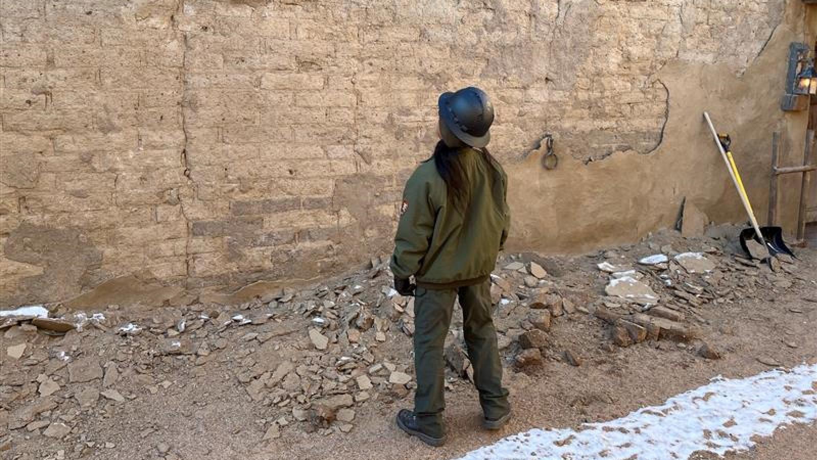 Park Ranger looks up at a failing wall