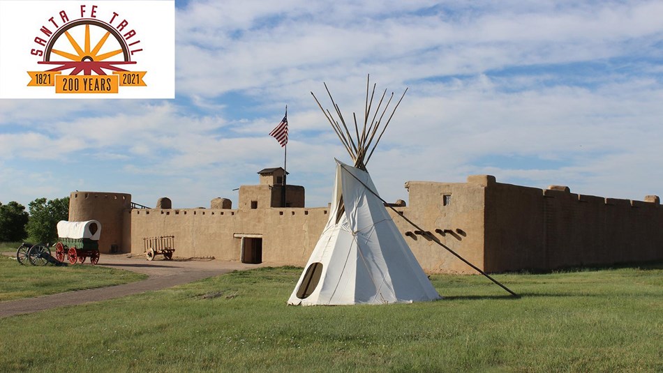 Reconstructed fort with tipi, wagon, cart and canon and Santa Fe Trail Bicentennial logo