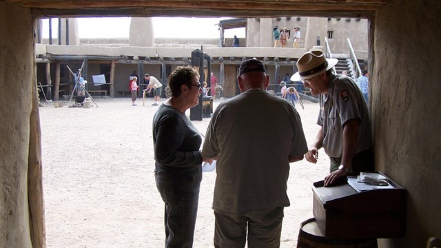 A ranger greets visitors at the entrance to the fort. 