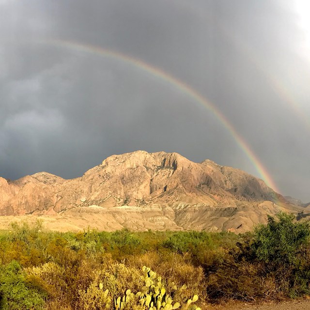 A rainbow frames the mountains of Big Bend.