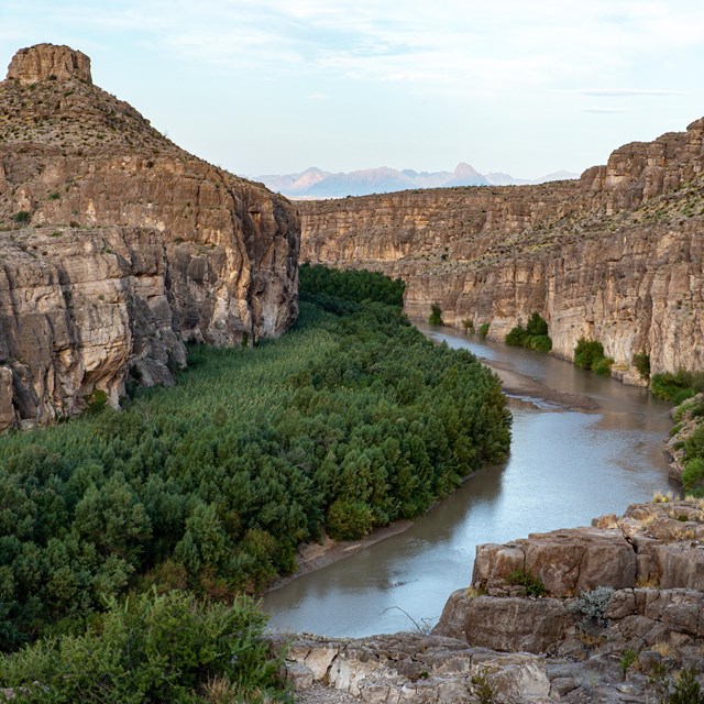 A river runs through a steep-sided canyon.
