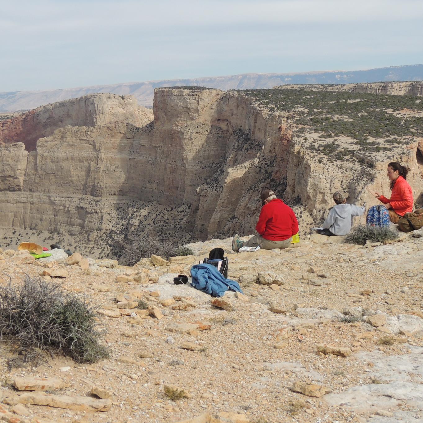 Several people participate in an art hike on the State Line Trail. 