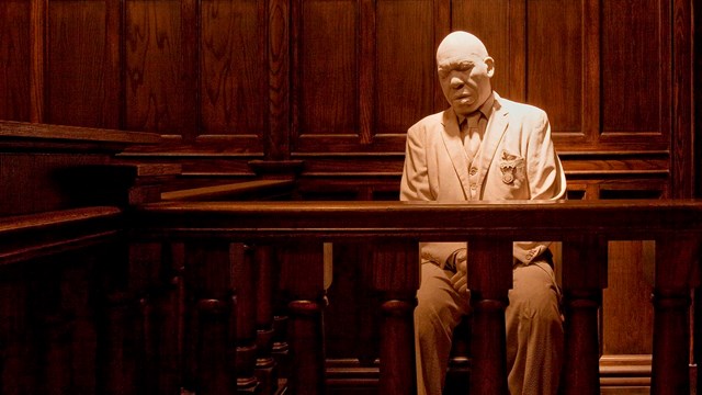 Sculpture of an African American man in a museum.