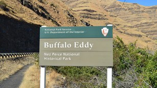 A green sign with the words "Buffal Eddy Nez Perce National Historical Park."