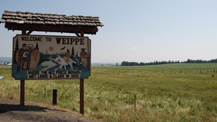 Wooden sign that reads "Welcome to Weippe where the Nez Perce Indians met Lewis and Clark in 1805."