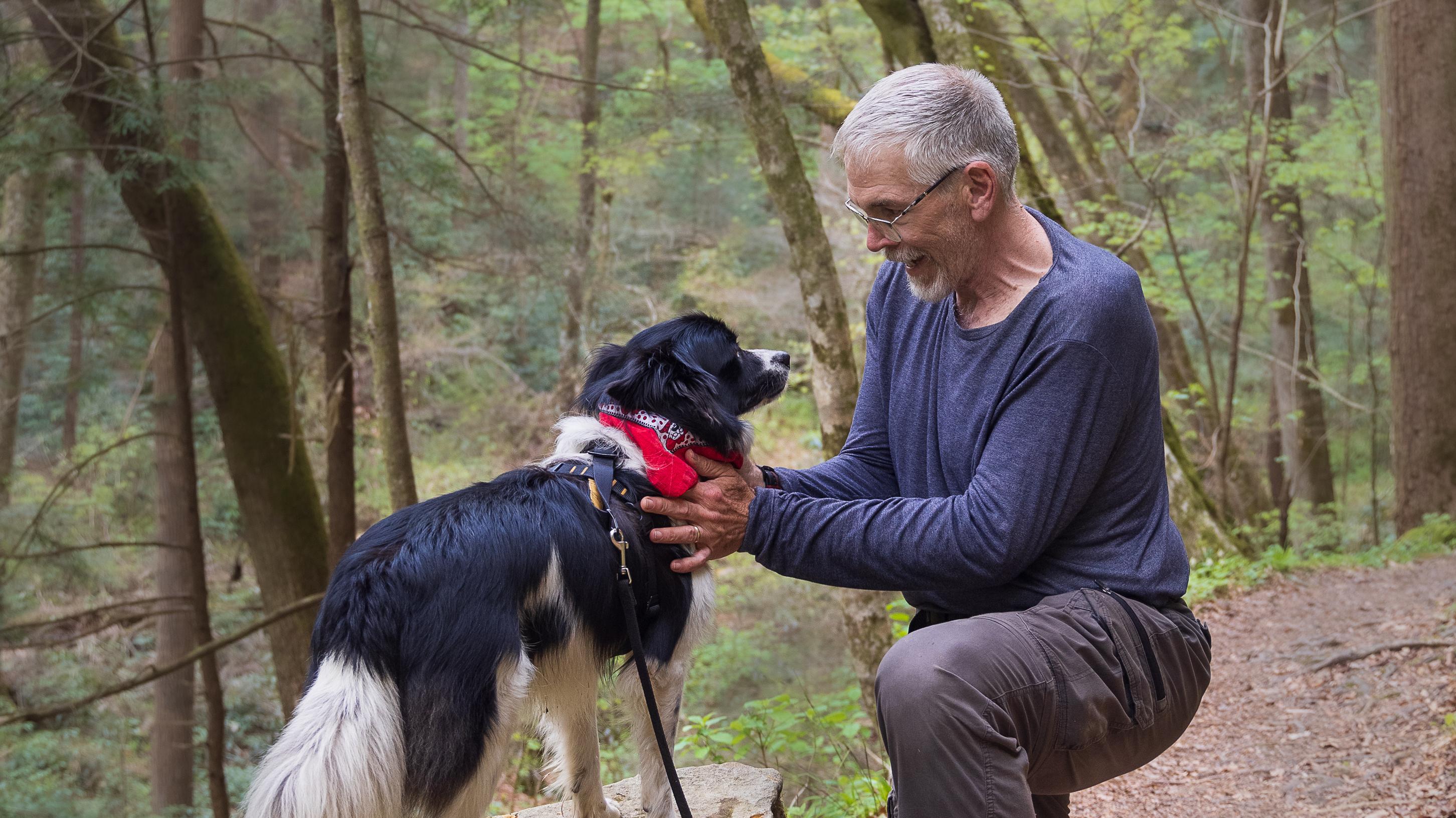 A hiker with his canine friend on a trial