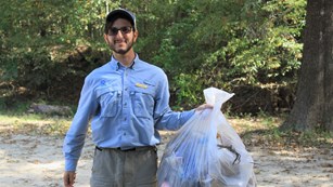 volunteer holding a bag of trash