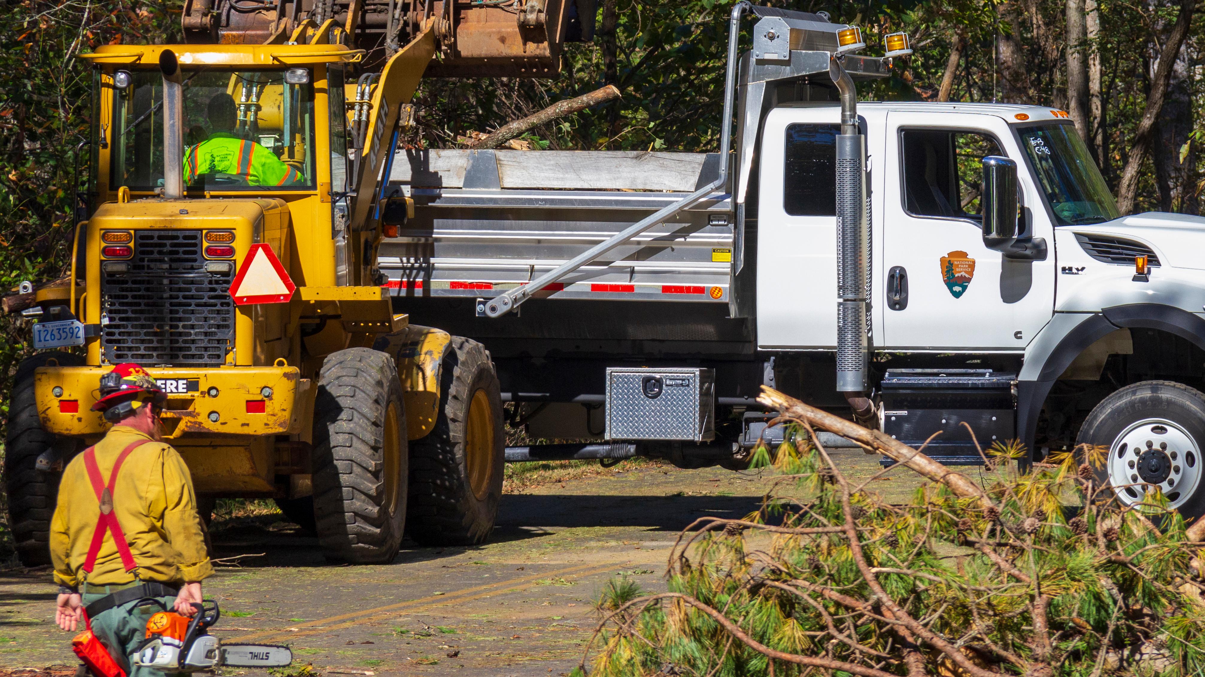 Equipment moves tree sections off roadway