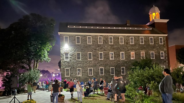 Wilkinson Mill at night with large group of people