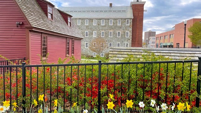 Spring day with flowers surrounding the Brown house and Wilkinson Mill