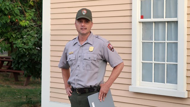 Photo of Ranger standing in front of Slater Mill