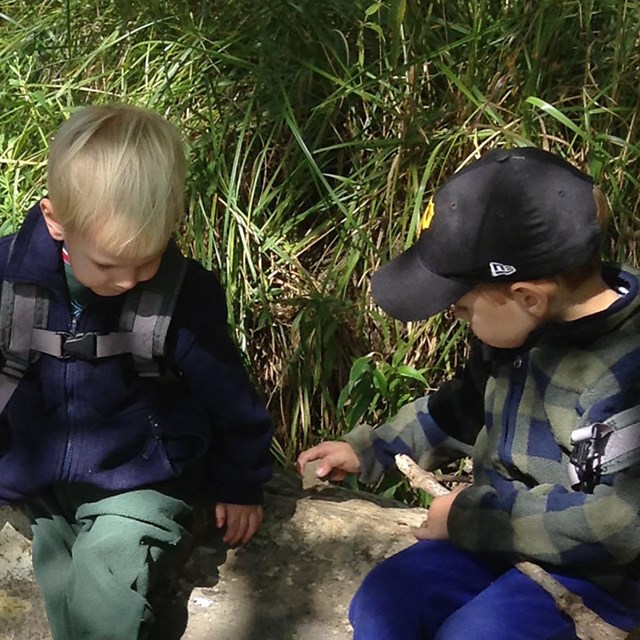 two kids playing by the water