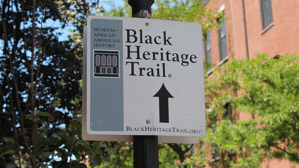 Black Heritage Trail® sign with arrow pointing in the direction of the trail.