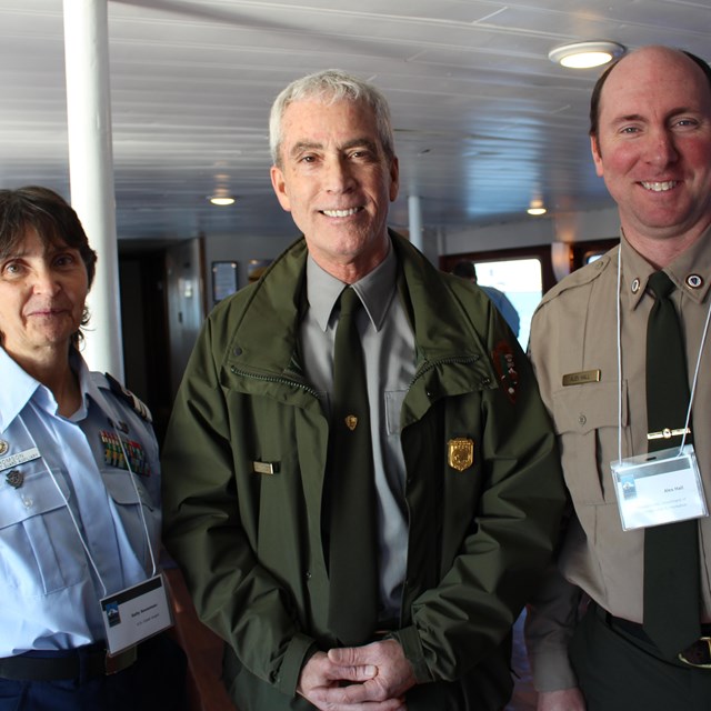 Coast Guard, National Park Service, and State Park Service employees stand together.