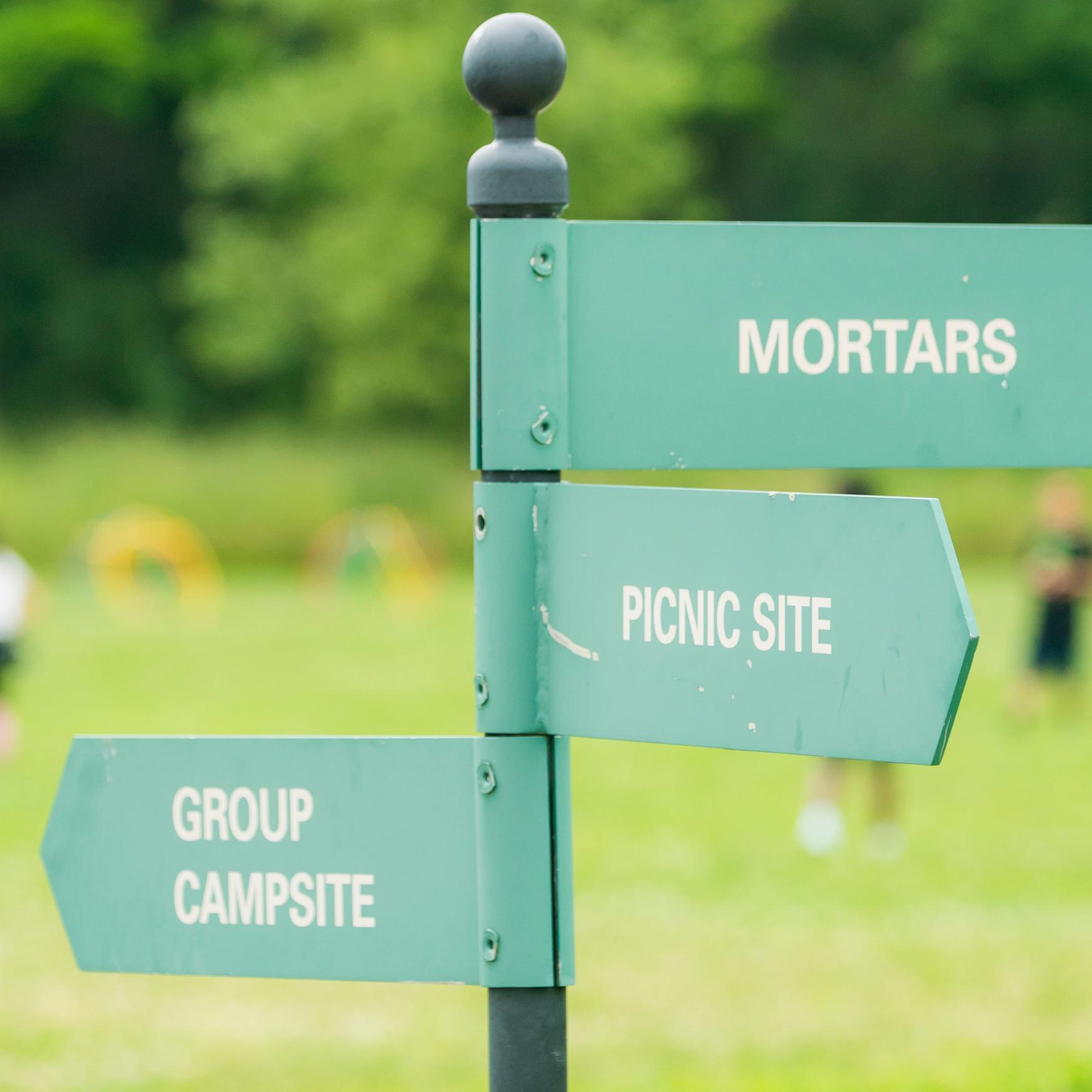 Signpost on Peddocks Island pointing to a campsite, picnic site, and mortars
