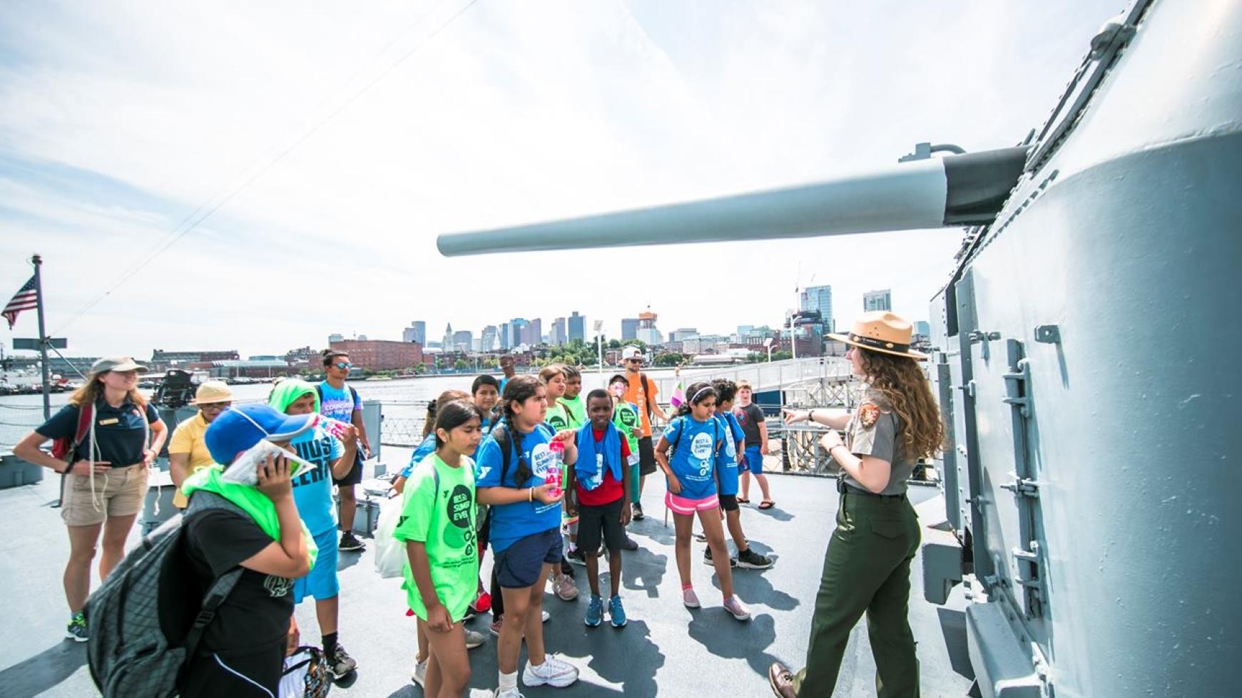 Ranger speaks to a group of school kids on board the USS Cassin Young.