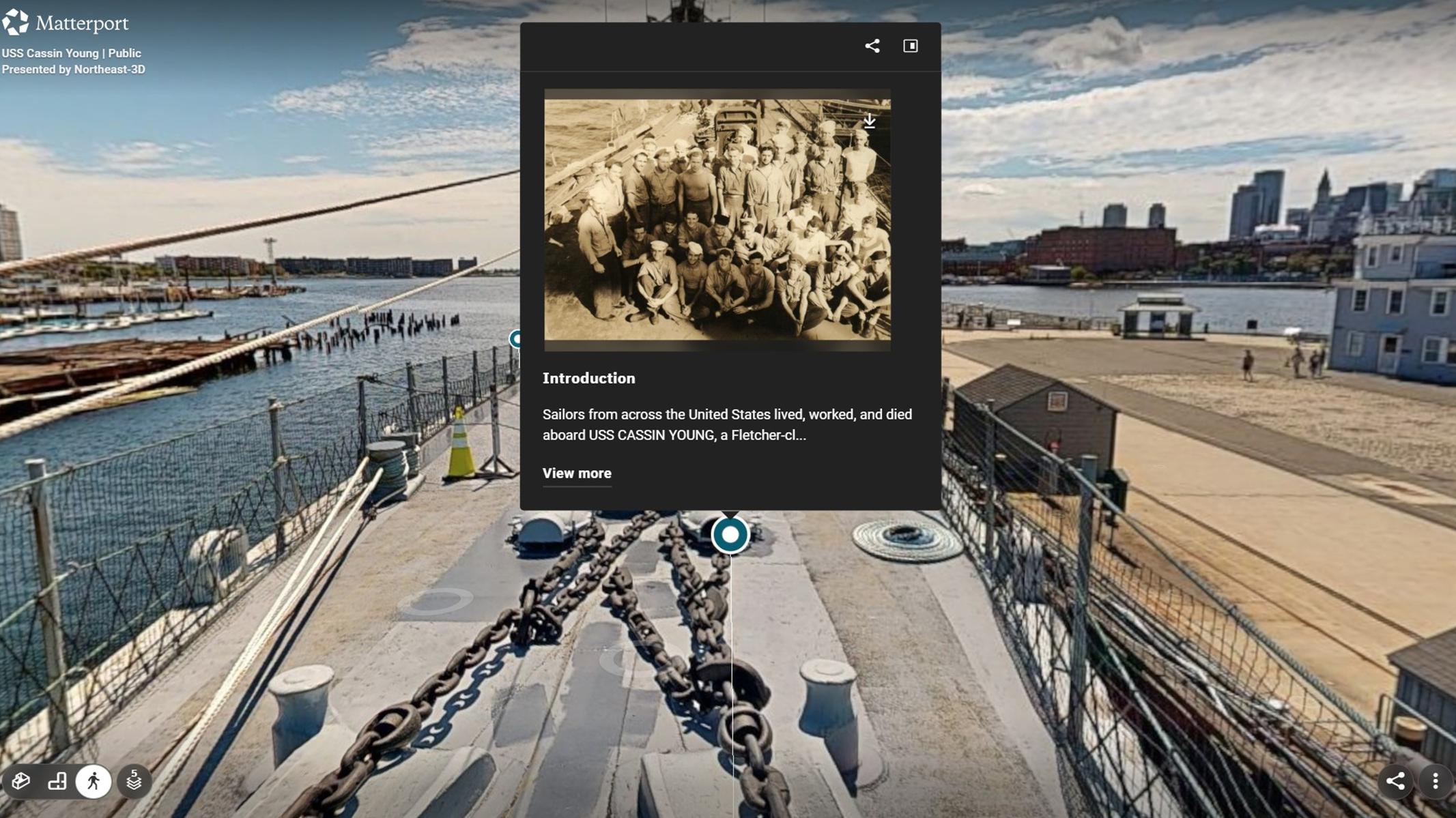 Virtual view of USS CASSIN YOUNG foredeck with a pop-up box showing a group photo of sailors.