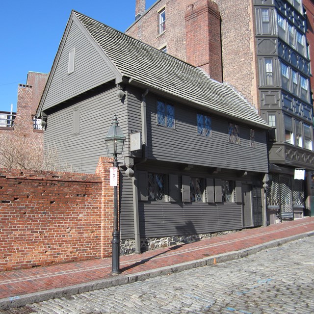 The grey painted wooden home of Paul Revere, as seen today.