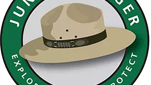 A large junior ranger hat with a brown band.