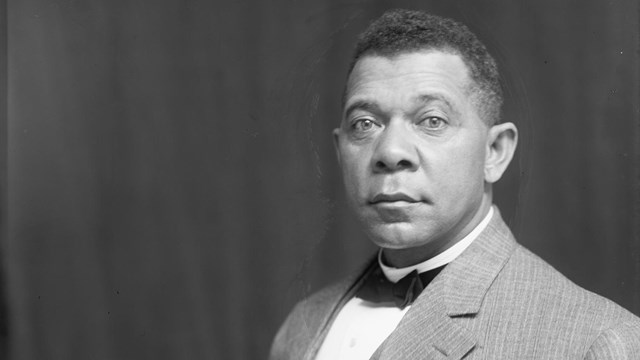 A half-length portrait of Booker T. Washington, seated, wearing a suit.
