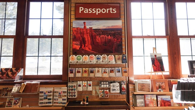A display of stickers, books, and a sign that reads Passports.